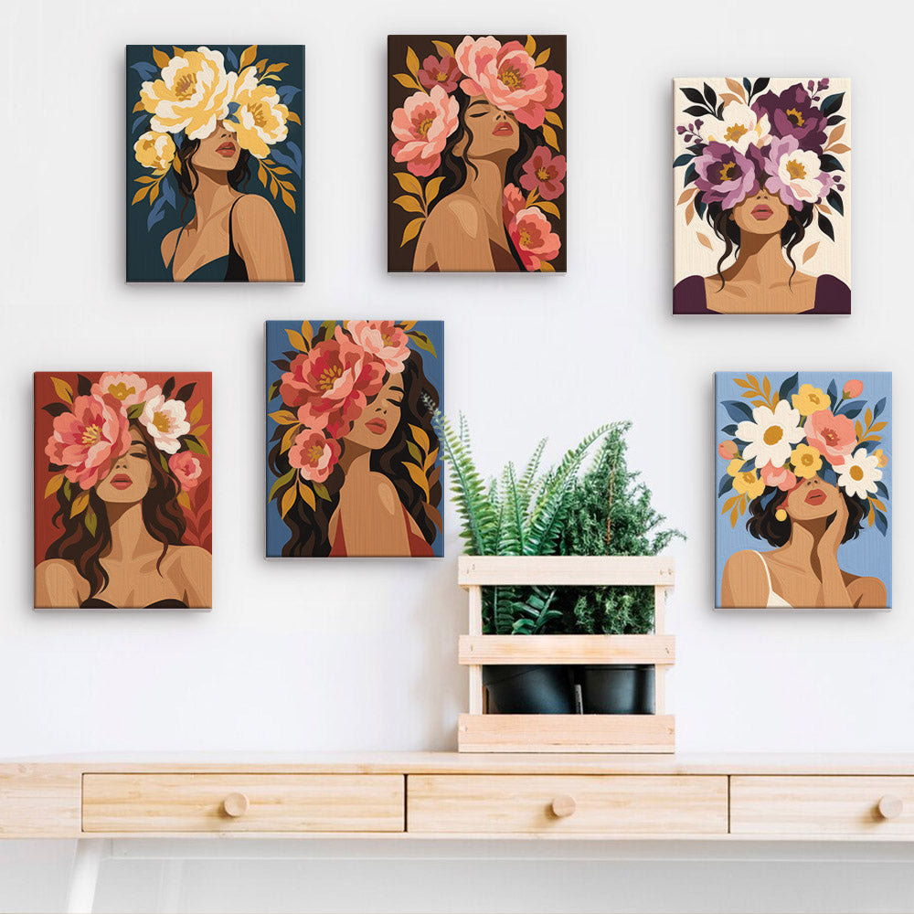 a collection of six framed artworks depicting women with flowers in their hair, arranged on a wall above a wooden shelf.