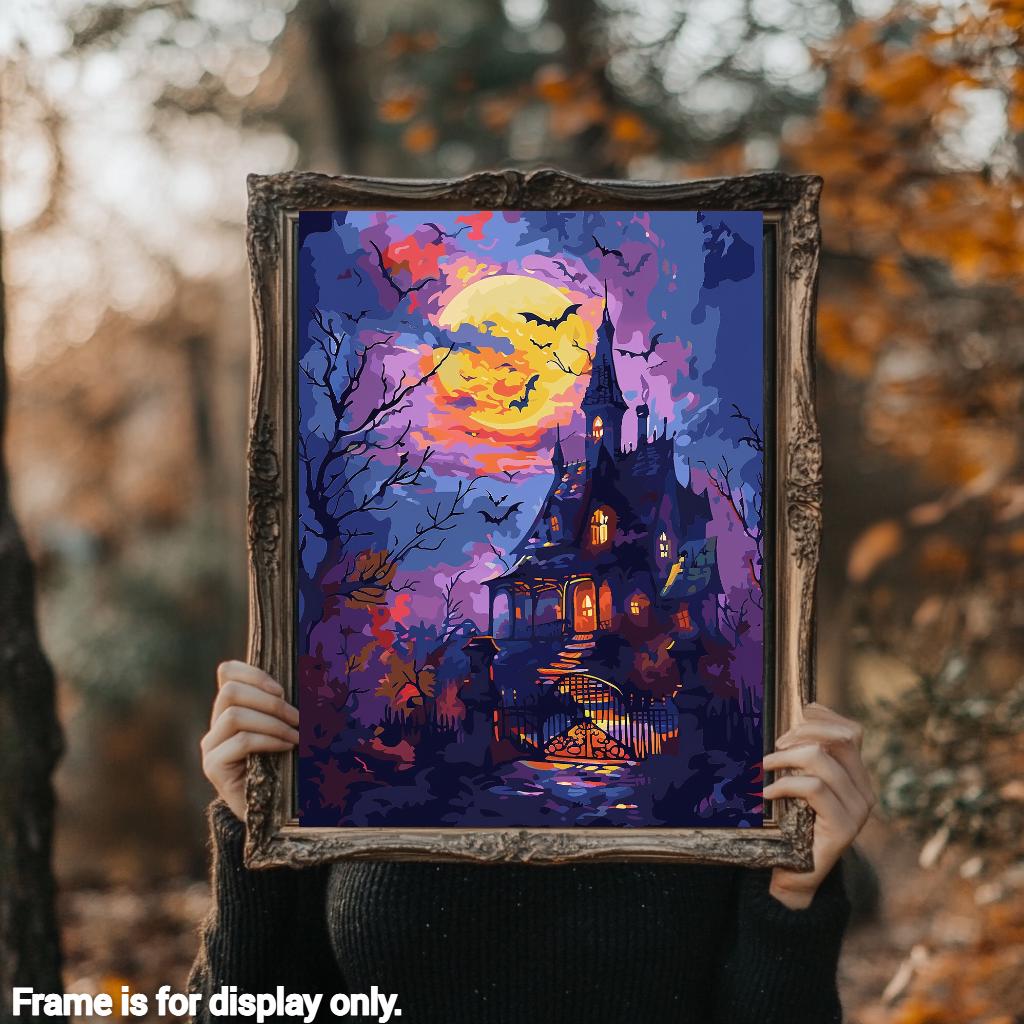 a woman holding up a painting of a house at night