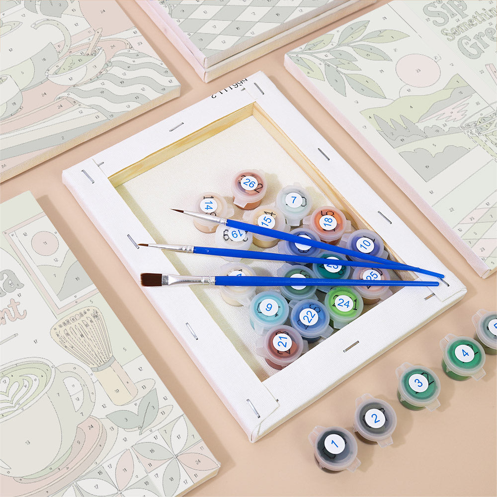 a painting kit with various art supplies, including paint tubes and brushes, arranged on a table.