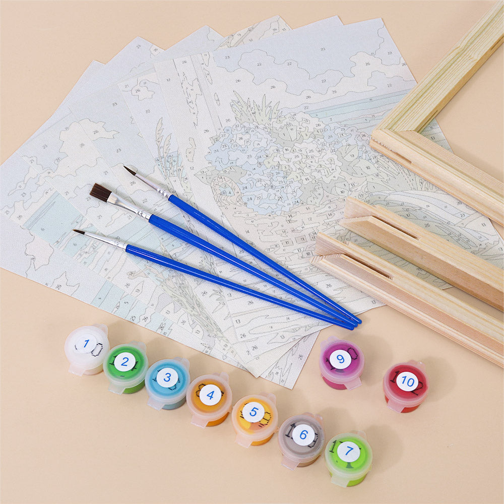 various art supplies, including paintbrushes, paint tubes, and a partially completed landscape painting.