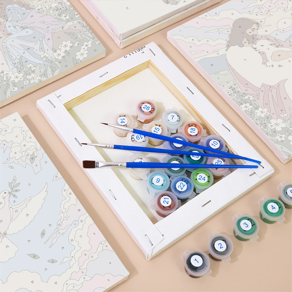 a painting kit with various art supplies, including paint tubes and brushes, arranged on a table.