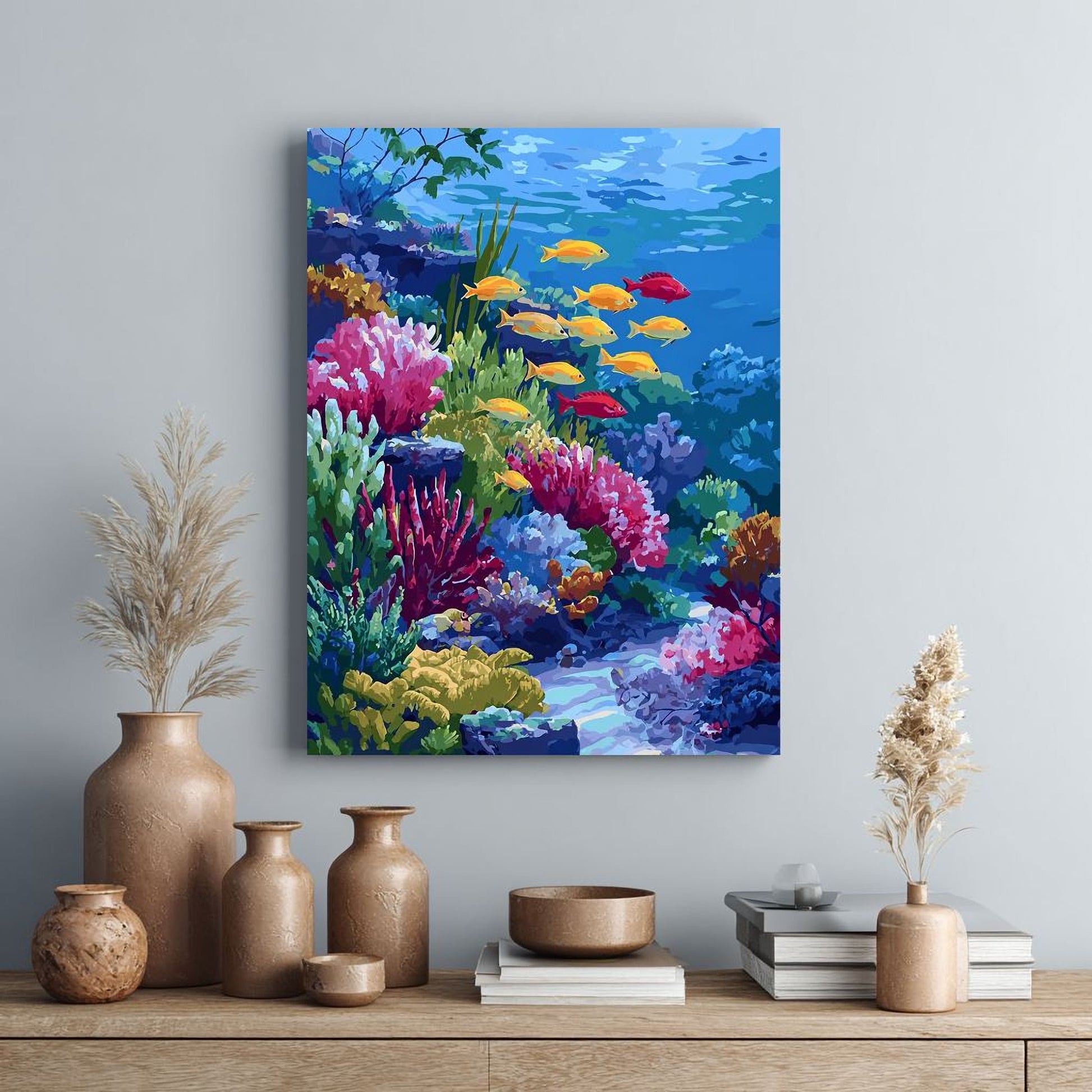 a vibrant underwater scene with a variety of colorful fish swimming amidst a lush coral reef. The painting is hung on a wall above a wooden shelf, which also displays several decorative vases and a stack of books.