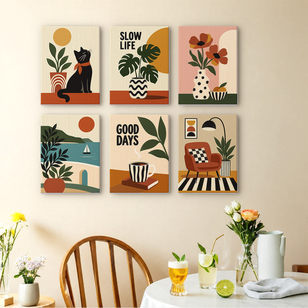 a wall with six colorful and stylized paintings arranged in a grid pattern. The paintings depict various scenes, including a cat, plants, flowers, and other decorative elements. The wall also has a dining table with chairs, a vase of flowers, and some drinks, creating a cozy and inviting atmosphere.