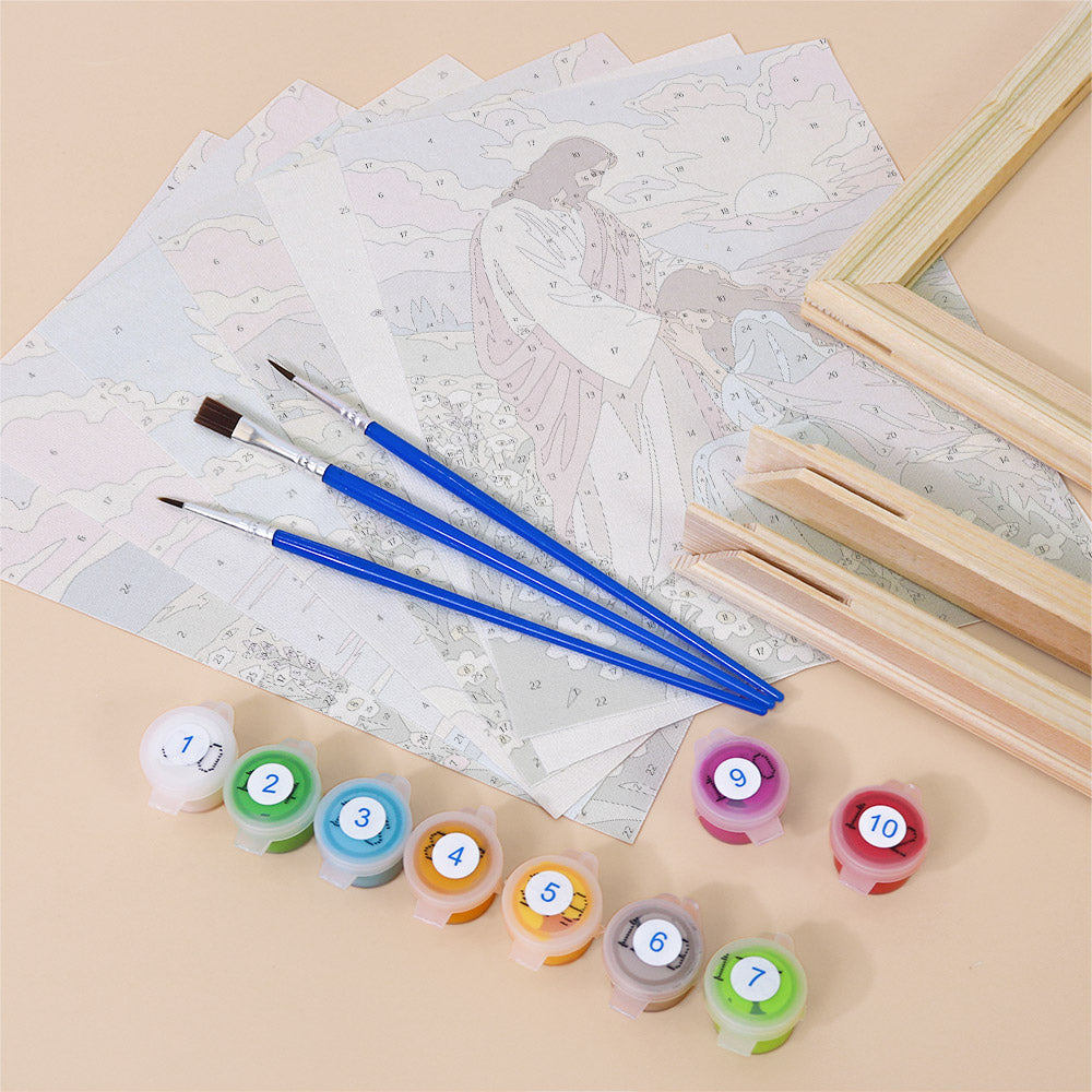 various art supplies, including paintbrushes, paint tubes, and a partially completed painting of a landscape.
