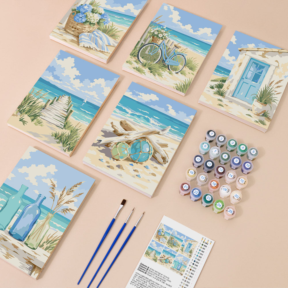 six paintings depicting beach scenes, along with paintbrushes, paint tubes, and a guidebook for painting.