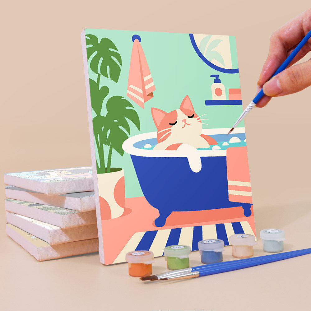 A hand is painting a picture of a cat sitting in a bathtub, surrounded by various art supplies such as paintbrushes and paint tubes.