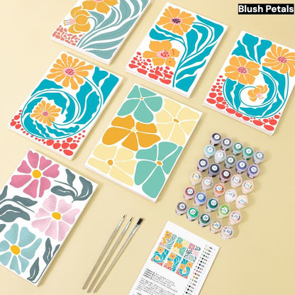 a collection of colorful floral designs, including various shades of yellow, orange, and pink flowers, as well as paint tubes and brushes, suggesting an art project or craft activity.