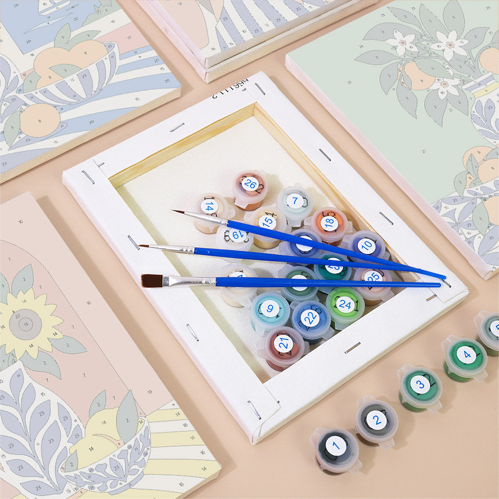 a painting kit with a canvas, paintbrushes, and multiple paint color containers.