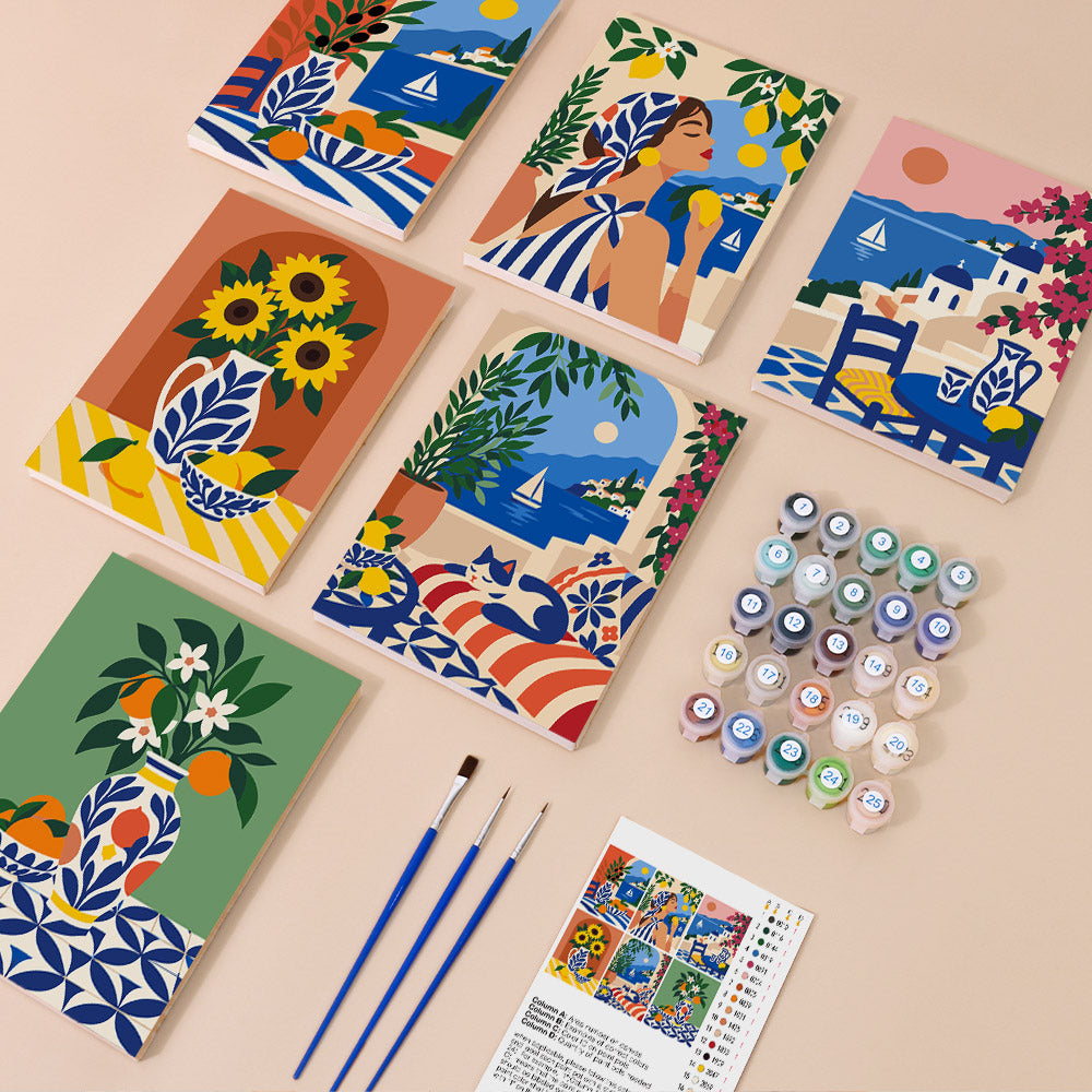 six colorful paintings depicting various scenes, such as vases, flowers, and boats, arranged on a light-colored surface. There are also paintbrushes and paint tubes, suggesting that this is an art kit or painting supplies setup.